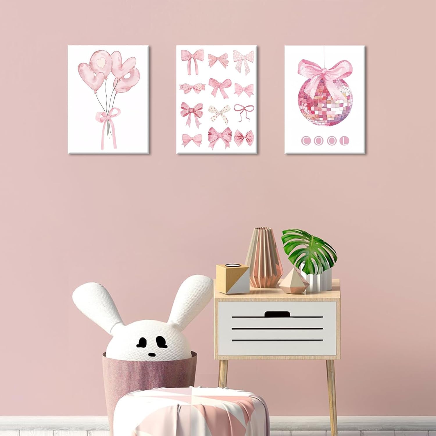 Preppy Pink Bow Wall Art displayed on a pink wall, featuring playful bows, balloons, and a disco ball canvas.